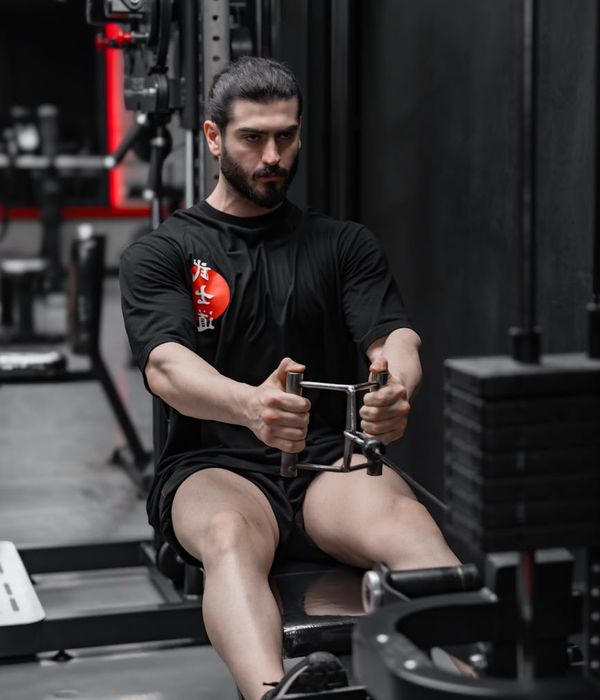 Man performing focused strength exercises in a minimalist modern gym setting